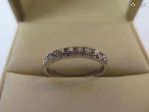 A good quality platinum and diamond half eternity ring, set with eleven brilliant cut diamonds, 0.