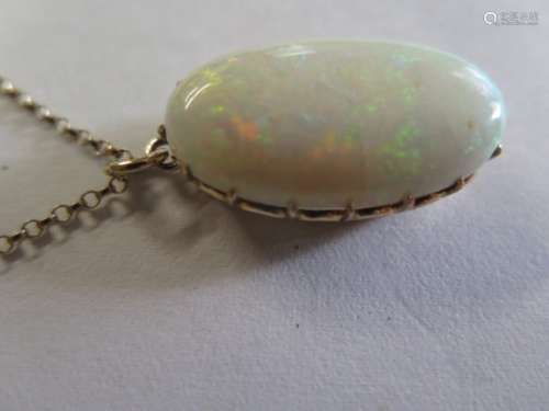 A large 9ct gold mounted white opal pendant on 9ct chain, the opal measures approx 30mm x 17mm, claw