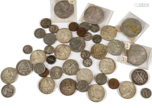 A small collection of American coins, including four dollars, 1878, 1879, 1898 and 1900, along