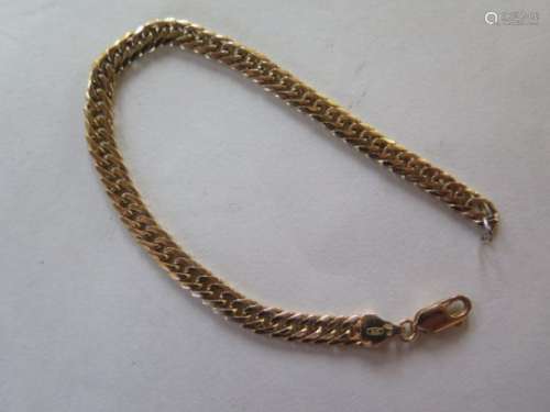 A 9ct yellow gold curb link bracelet, marked 375 - 18cm long, with replacement base metal link,