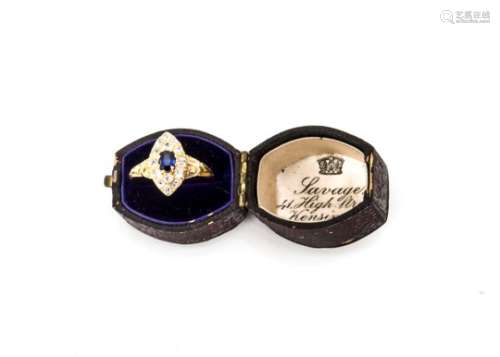 An Edwardian sapphire and diamond navette shaped cluster ring, the central oval cut blue sapphire