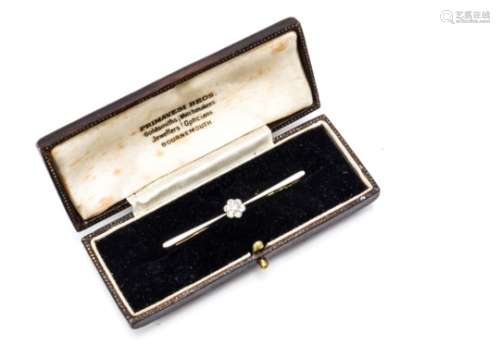 A diamond and platinum daisy head bar brooch, the old cut diamonds centre set to bar on a yellow