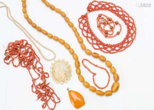 Two 19th Century coral bead necklaces, an amber pendant, a 19th Century bone carved brooch of a