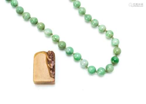 A string of green jadeite jade knotted circular beads, clasp broken, 38cm, 9.5mm diameter together