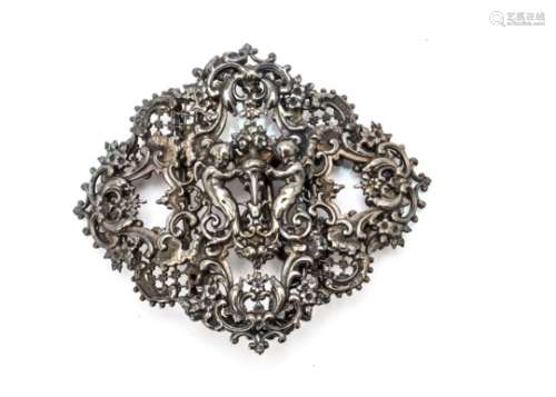 An ornate Victorian silver nurses buckle, centred with winged cherubs within a rococo border with