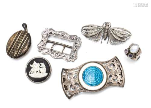 A Victorian silver oval locket, a Victorian pierced and shaped silver belt buckle, a George V silver