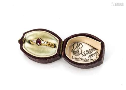 A late Victorian 18ct gold ruby and diamond ring, the central oval mixed cut ruby in claw setting