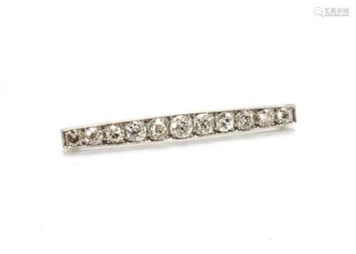 An early 20th Century white metal diamond set bar brooch, of elongated oval form, the eleven old cut