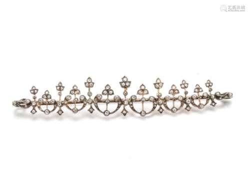 A 19th Century converted diamond set brooch, the stylised flower heads in crescents in alternate