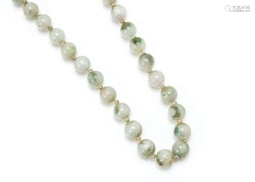 A Chinese pale jadeite Jade uniform string of knotted beads, with silver filigree Chinese clasp,