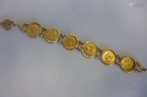 A 9ct gold half sovereign bracelet, set with six 1916 half sovereigns, with heart shape padlock