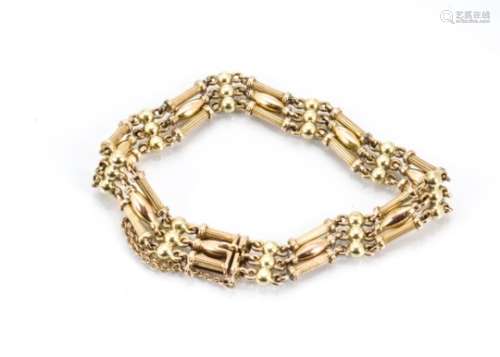 A 15ct gold three bar bracelet, the tongue and box clasp marked 15 with fluted column links