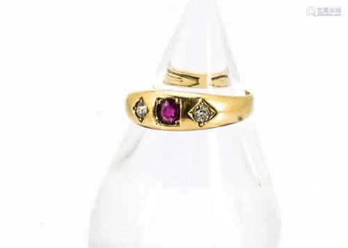 A Victorian 18ct gold diamond and ruby three stone ring, centred with oval ruby and two old cut