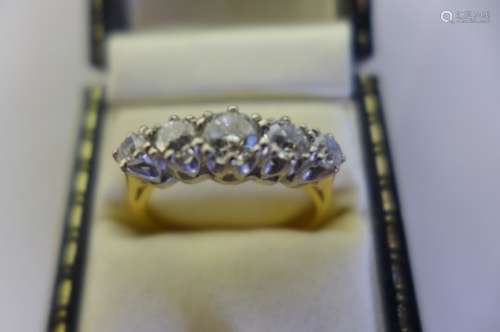 An 18ct five stone diamond ring, the largest stone approx 1/2ct, approx 1.2 carats total, size Q,