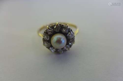 An 18ct pearl and diamond cluster ring, the central pearl diameter 5.5mm, surrounded by ten diamonds