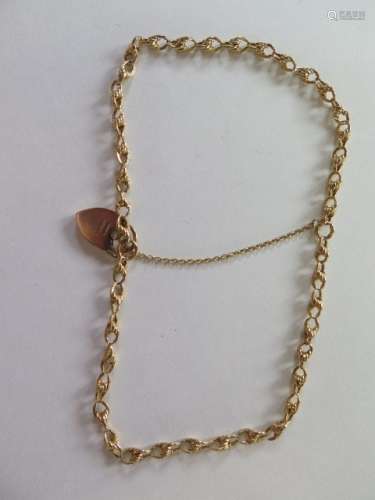 A 9ct gold bracelet with padlock, probably adapted from a chain, total weight approx 27.6 grams,