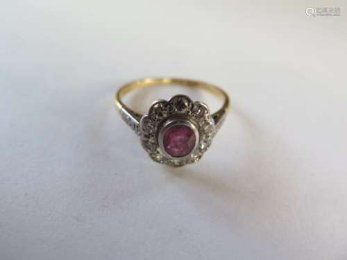 An 18ct gold ruby and diamond ring, size P, approx 2.8 grams, some usage marks and wear but
