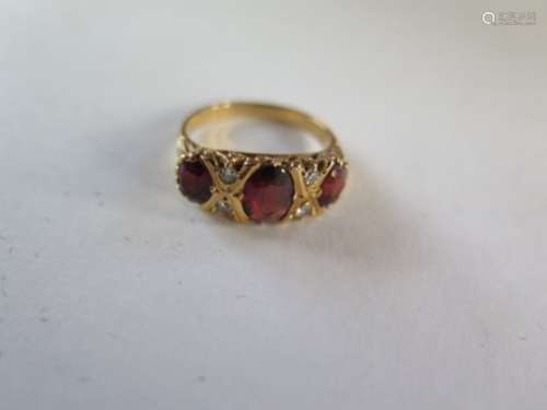 An 18ct gold garnet and diamond ring, size L - approx 4.6 grams, generally good, some minor wear,