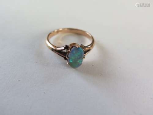 An 18ct yellow gold opal ring, size P, approx 2.8 grams, some wear to stone otherwise generally good