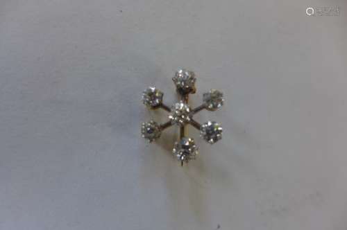 A gold seven stone diamond brooch, total approx 1.1ct, 17mm wide, approx 2.5 grams, tests to 18ct,