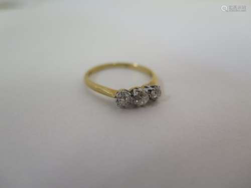 An 18ct yellow gold three stone diamond ring, size O, approx 2.4 grams, generally good, minor