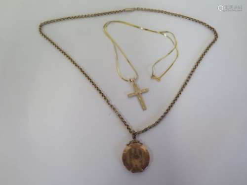 A gold crucifix, tests to approx 9ct, 1.6 grams on a 14ct chain, 1.4 grams, and a 9ct locket and