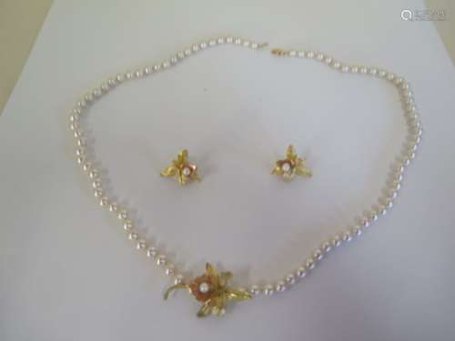 A pearl necklace, with floral pendants and matching earrings, clasp marked 14ct, weight of