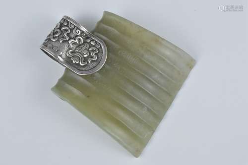 A Chinese jade hat piece with silver metal mount