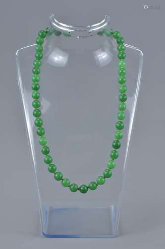 A graduated jade bead and 18ct white gold necklace