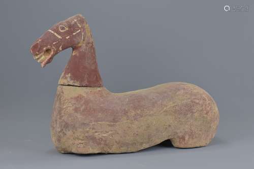 A Chinese Han dynasty pottery seated horse