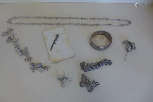 A silver bangle, necklace and charm bracelet, a white metal sabre and scabbard, 6cm long, and