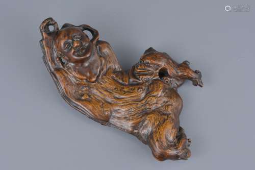 A Chinese wood carving of Liu Hai