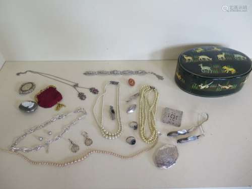 An assortment of silver and costume jewellery in a papier mache box