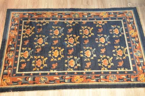 A large Tibetan / Chinese 19th century dark blue ground rug