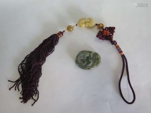 A carved jade pendant - 5x4cm - and a carved jade lion pendant on tassel pendant, length 4cm, both