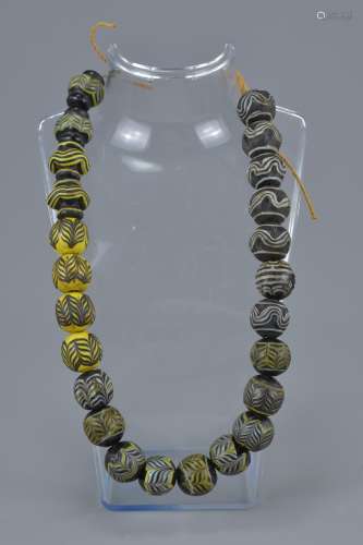 Twenty Four Antique Islamic Glass Beads