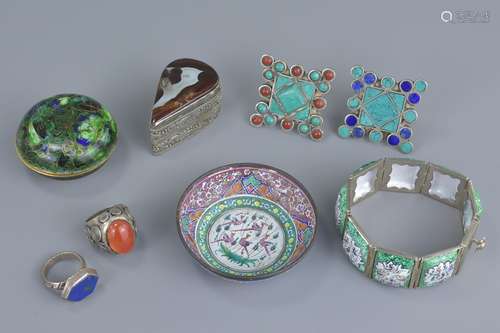 A group of seven white metal and enamel items