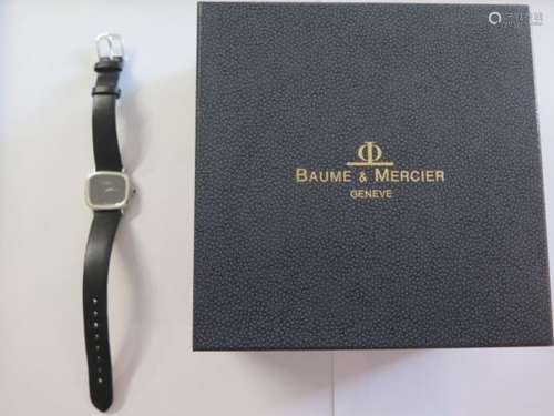 An 18ct white gold ladies Baume and Mercier wrist watch with cabachon sapphire crown, plain black