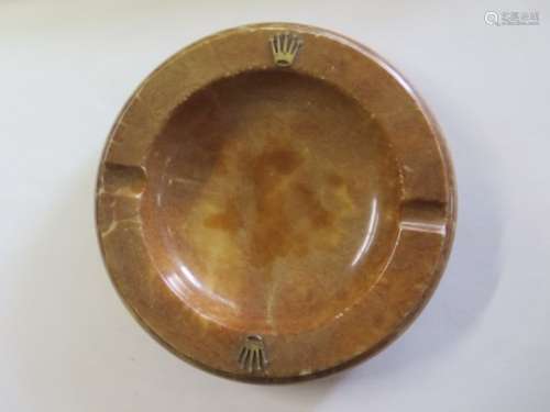 A brown alabaster Rolex ashtray with gold crown mounts, diameter 20cm, some minor wear/flaking of