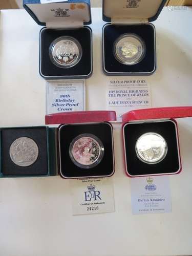 Four silver proof commemorative coins, and a 1950 crown