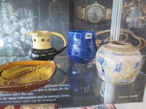 A Brannam ware jug, puzzle/motto jug and two studio pots