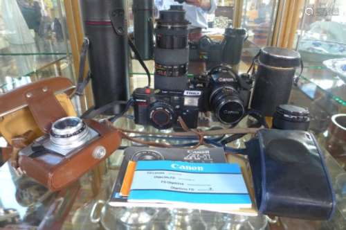A Canon A-1 SLR camera, an Olympus AFL quick flash, an Agfa Optima and a Tamron zoom lens and a