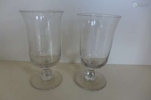 A pair of bell shaped glass candle stands, 22cm tall