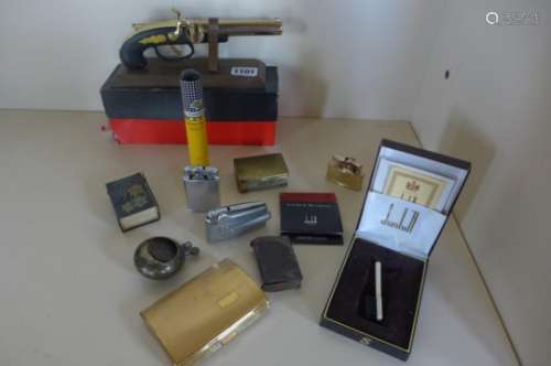 A collection of smoking related items, including a Derringer pistol lighter