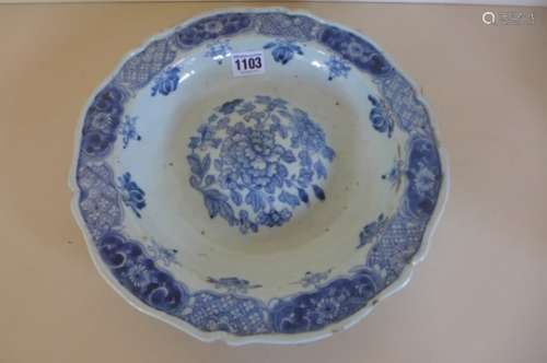 A Chinese 18th century blue and white dish with a raised central boss, decorated with flowers of the