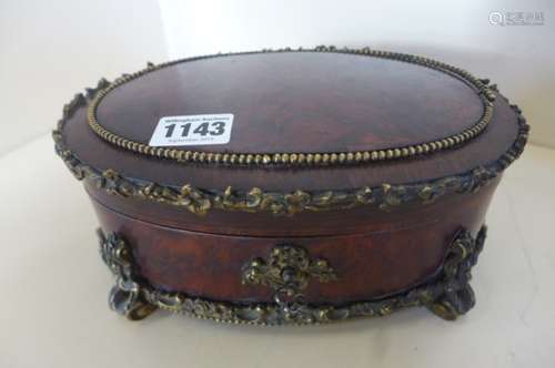 A very fine quality French Amboyna and ormulu jewellery casket, oval in shape, the top cross