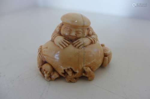 A very good Japenese Meji period, early 1900's carved ivory nesture of a rice seller, asleep with