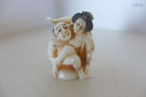 A Japanese late Meiji period, early 1900's erotic okimono carved in ivory and signed, incised and