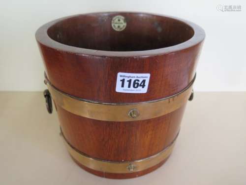 An oak planter, with copper banding, 19cm tall, 21cm diameter