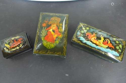 Three modern Russian lacquer boxes in black lacquer with hand painted decoration, all three with